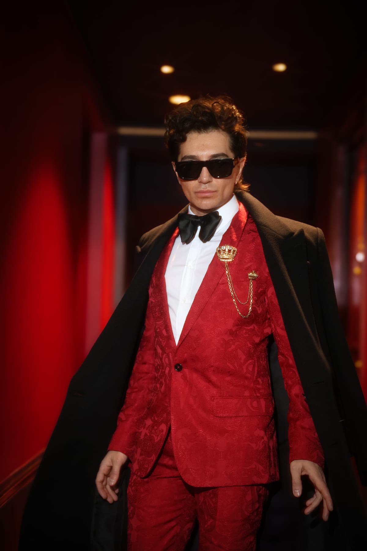 Red tuxedo, sunglasses and coat in the red corridor, private birthday in Paris