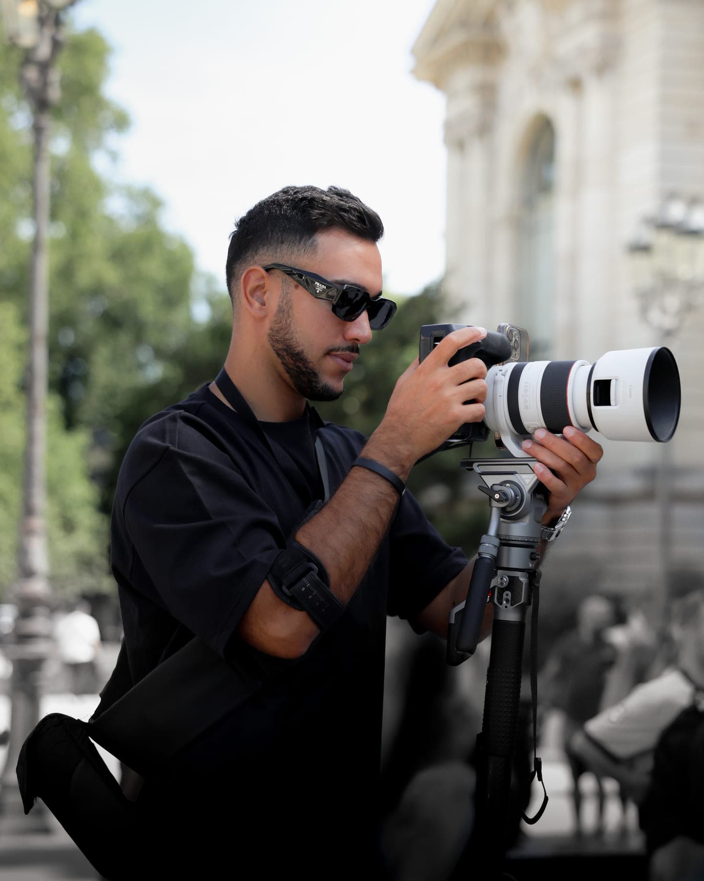 Visual Twins photographer shooting on location with a telephoto lens on a monopod